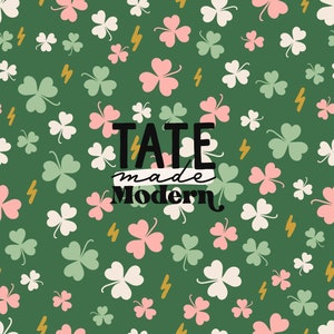 May include: A green background with a repeating pattern of white, pink, and green four-leaf clovers. The text "TATE made Modern" is in black lettering in the center of the image.