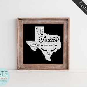 May include: A black and white graphic design featuring the outline of the state of Texas with the word "Texas" and "Est. 1845" inside the state outline. The graphic also includes a cowboy hat, a pair of boots, a longhorn steer, and musical notes.