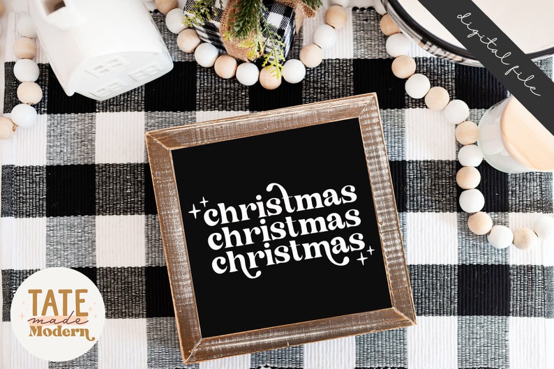 Pode incluir: Uma placa preta enquadrada com o texto "christmas christmas christmas" em branco sobre um fundo xadrez preto e branco.