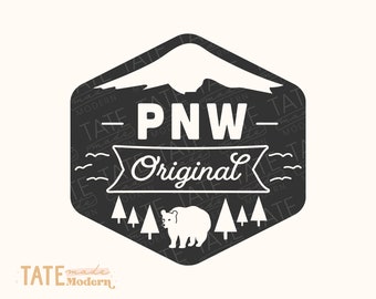 May include: Black and white graphic design of a mountain range, a bear, and trees with the text "PNW - Original" in a banner. The design is surrounded by a repeating pattern of the text "TATE made Modern".