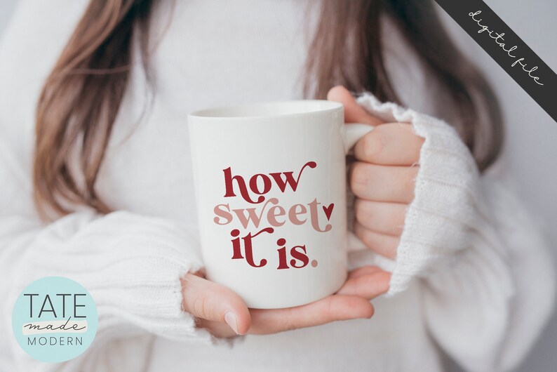May include: White ceramic mug with the text "how sweet it is." in red and pink lettering. A small heart is included in the text.