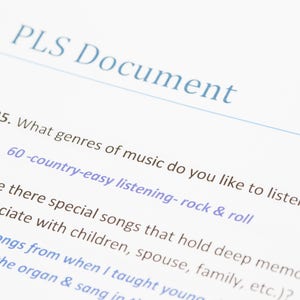May include: A page from a document titled "PLS Document" with two questions. Question 35 asks "What genres of music do you like to listen to?" and lists "country-easy listening-rock & roll". Question 36 asks "Are there special songs that hold deep memories for you associate with children, spouse, family, etc.?"