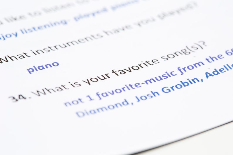 May include: A close-up of a survey question asking "What is your favorite song(s)?" with a list of artists including Diamond, Josh Grobin, and Adele. The question is numbered 34.