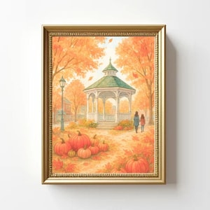 May include: A framed watercolour painting of an autumnal scene. The artwork depicts a gazebo with a green roof, surrounded by orange trees and pumpkins. Two figures walk along a path. The frame is gold.