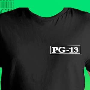 May include: Black t-shirt with the text "PG-13" in a white rectangular box on the chest. The upper left corner of the shirt has the text "BOX OFFICE" with a barcode design.