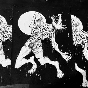 May include: Three black and white embroidered patches featuring a creature with a human-like body and a wolf-like head, with its skin peeling off, against a full moon background.