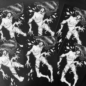May include: A collection of five identical rectangular art prints featuring a high-contrast black and white illustration of a figure with long flowing hair, wrapped in bandages, and surrounded by floating shards against a solid black background.