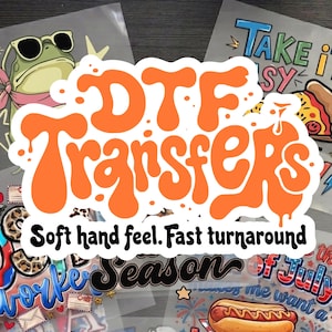 May include: A collection of DTF transfers featuring various graphic designs including a frog with sunglasses, a slice of pizza, and a hot dog. The central text reads DTF Transfers with the subtext Soft hand feel. Fast turnaround in black.