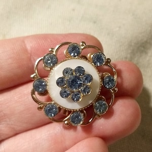 Gold tone brooch with blue glass rhinestones