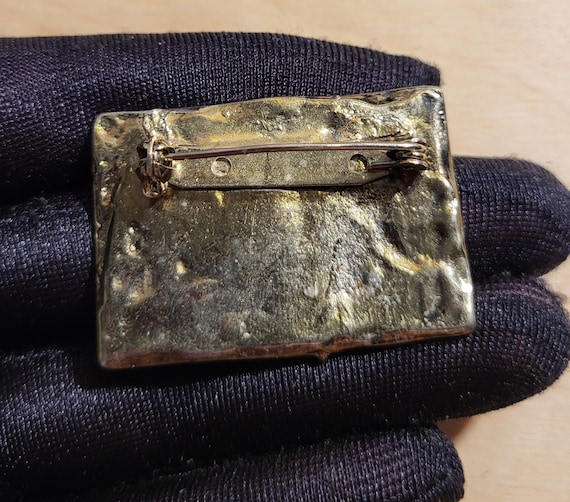 Flat rectangular silver-tone brooch with tire tre… - image 2