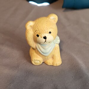 Small bisque ceramic teddy bear figurine with blue bandana