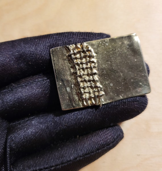 Flat rectangular silver-tone brooch with tire tre… - image 1