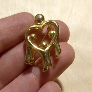 Camco parent with three children hugging family open heart brooch