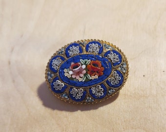 Oval-shaped glass mosaic millefiori blue brooch with red rose floral theme
