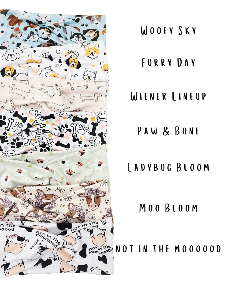 May include: A stack of fabric headbands with various patterns. Designs include dogs, bones, ladybugs, and cows. Text on the image reads "Woofy Sky", "Furry Day", "Wiener Lineup", "Paw & Bone", "Ladybug Bloom", "Moo Bloom", and "Not in the Mooood".