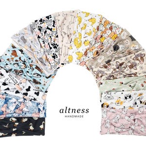 May include: A collection of handmade headbands in various patterns, including dogs, cats, ducks, and paw prints. The headbands are arranged in an arch shape, showcasing the variety of designs. The brand name "altness" is displayed in the center.