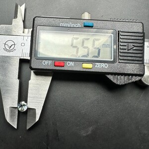 May include: A close-up of a digital caliper measuring a small, light blue gemstone. The caliper reads 5.5 mm.