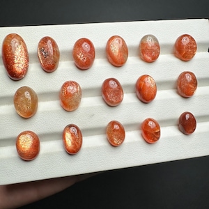orange sunstone cabochon with golden fire