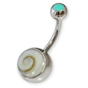 May include: A silver belly button ring with a turquoise top and a white shell with a brown swirl pattern on the bottom.