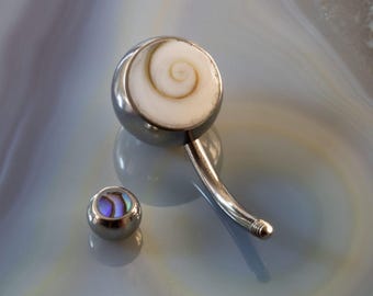 May include: A silver body jewelry set with a white shell and iridescent abalone shell accents.