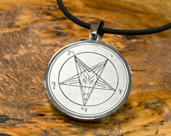May include: A silver pendant necklace with a black cord. The pendant features a pentagram with a goat's head inside and Hebrew characters around the edge.