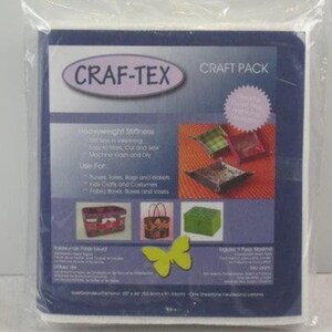 May include: A pack of white, heavyweight interfacing fabric called "Craf-Tex" Craft Pack. The package shows images of various craft projects, including purses, bags, and baskets. The text on the package reads "Heavyweight Stiffness", "Easy to Mark, Cut and Sew", "Machine Wash and Dry", "Use For: Purses, totes, bags and storage, Kids Crafts and Costumes, Fabric bowls, boxes and vases".