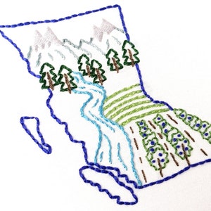 May include: Embroidered design of the Canadian province of British Columbia, featuring a blue outline of the province with mountains, a river, and trees in green and brown.