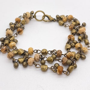 Neutral toned multi strand beaded bronze bracelet