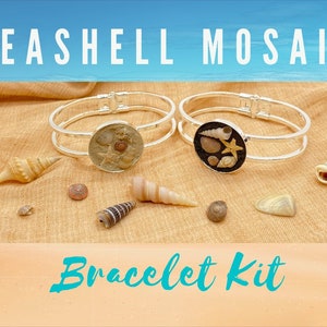 May include: Two silver bangle bracelets with a seashell mosaic design. The bracelets are on a tan fabric background with seashells scattered around them. The text "Seashell Mosaic Bracelet Kit" is at the top of the image.