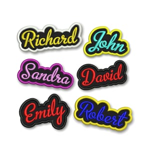May include: Six embroidered iron-on patches with names in different colors. The names are Richard, John, Sandra, David, Emily, and Robert.