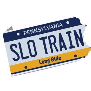 May include: A blue and white Pennsylvania license plate with the text "SLO TRAIN" in yellow letters and the words "Long Ride" in black letters.