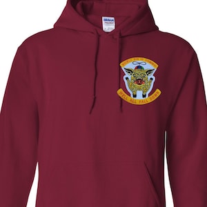 May include: Burgundy hoodie with a front pocket and drawstring hood. The hoodie features a patch with a pig illustration and the text "Whirly Pig Is Coming" and "Well All Fall Down".