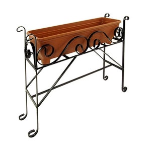 May include: Black metal plant stand with a decorative scrolled design. The stand has a rectangular planter box on top.