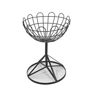 May include: Black metal wire basket with a wide, round bowl and a tripod stand. The stand has a circular base.