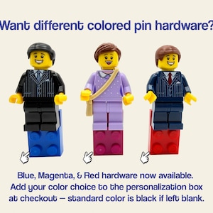May include: Three LEGO minifigures standing on blue, magenta, and red bricks. Text reads: Want different colored pin hardware? Blue, Magenta, & Red hardware now available. Add your color choice to the personalization box at checkout &ndash; standard color is black if left blank.