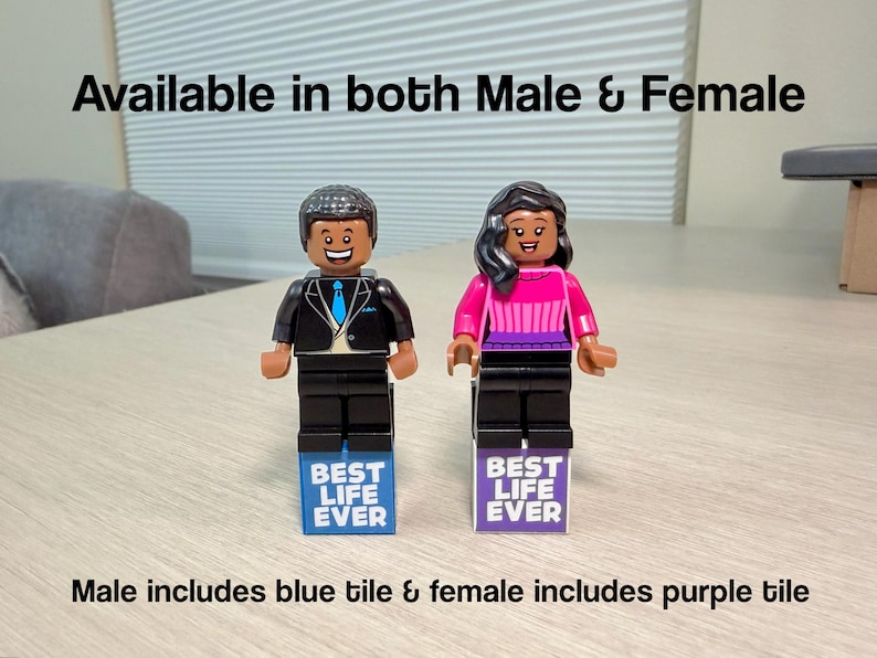 May include: Two LEGO minifigures standing on rectangular tiles. The left figure wears a black suit with a blue tie, standing on a blue tile reading BEST LIFE EVER. The right figure wears a pink and purple top, standing on a purple tile reading BEST LIFE EVER.