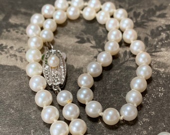 5mm Akoya pearl Mikimoto necklace. Princess length 18 inches with silver and pearl set clasp