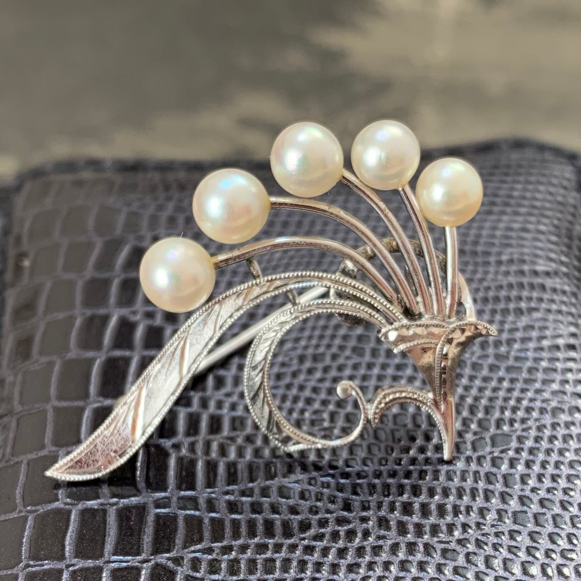 Mikimoto pearl brooch. 5mm gem quality akoya pearls in a Mikimoto pearl brooch. 5mm gem quality akoya pearls in a