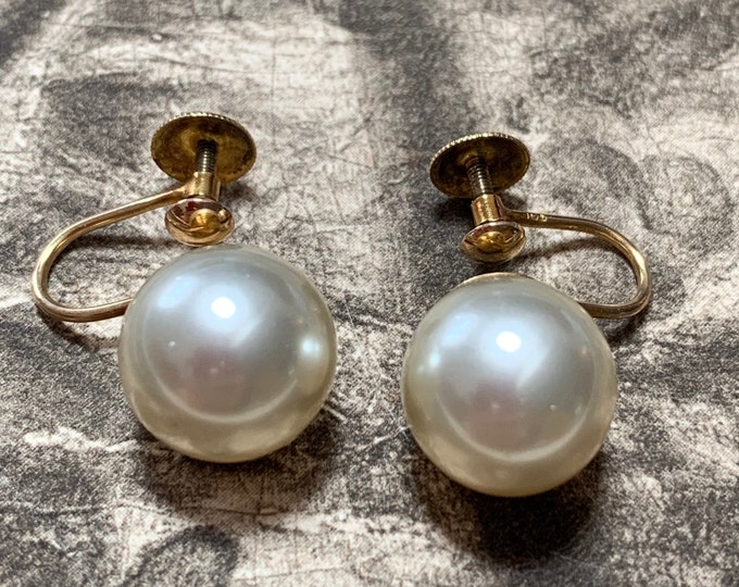 Vintage gold screwback earrings. Cira 1960s. quality 11mm faux pearls set to a heavy 9ct gold screw back fitting