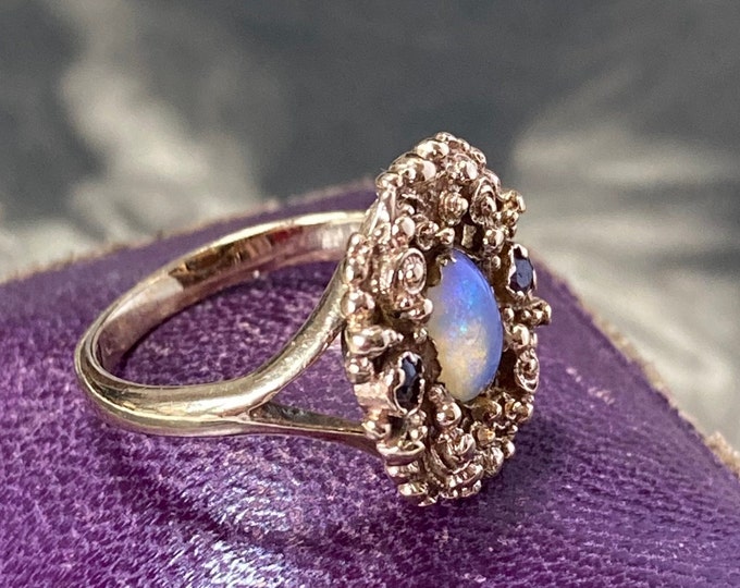 Opal gold ring with 2 rubies.  Ring size F or size  3 (US). 12ct yellow gold