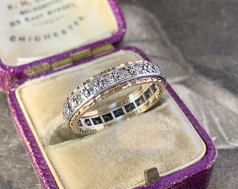 A stunning vintage full eternity ring.  Set with tiny bright and sparkling white quartz stones around the entire band in 9ct yellow gold