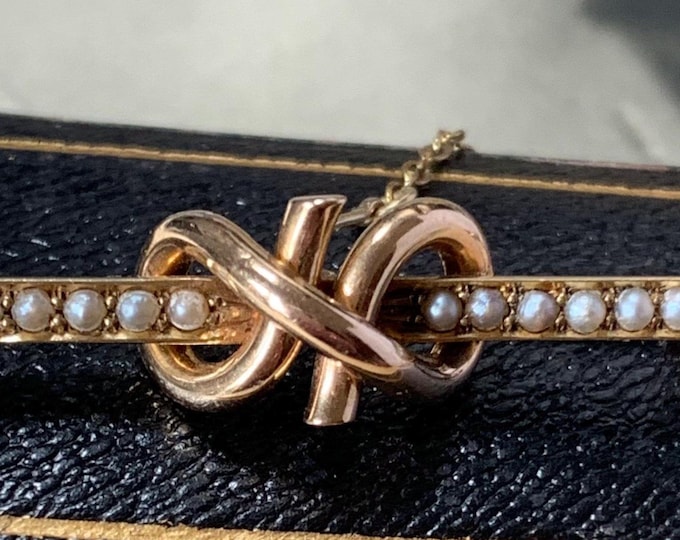 Lovers knot gold brooch. Edwardian 15ct gold brooch Pearl set with original antique box Gold safety chain  3.3 grams. 4cm long