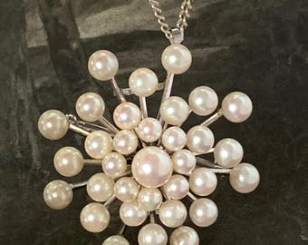 Pearl starburst brooch. 33 akoya pearls. 8mm-4mm graduated akoya pearls set in Sterling silver. 23 grams weight lovely pinkish hues