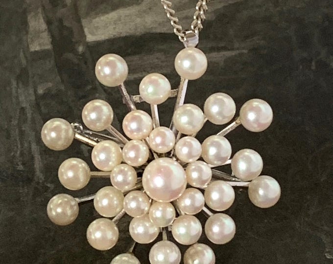 Pearl starburst brooch. 33 akoya pearls. 8mm-4mm graduated akoya pearls set in Sterling silver. 23 grams weight lovely pinkish hues