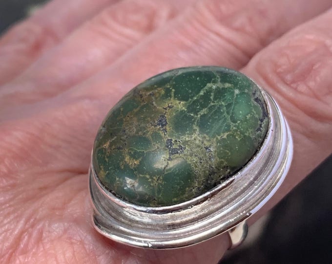 Vintage 1970s statement ring features a stunning turquoise oval cabochon stone set in silver Ring size Q size 8 US. 17 grams weight