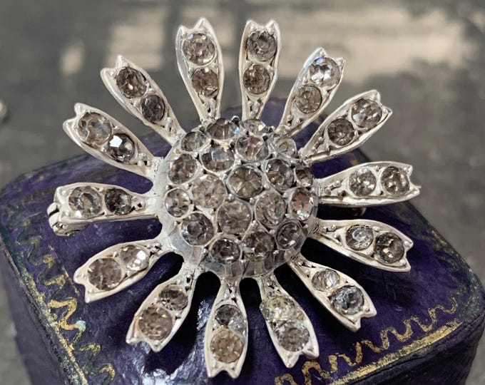 Starburst Silver brooch. Paste stones in closed back setting. Solid silver 9.4 grams. Edwardian silver brooch