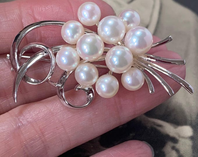 1960s Mikimoto Akoya pearl brooch. 11 AAA quality 6mm - 7mm pearls  Rolling wave design. 10.5 grams Sterling silver