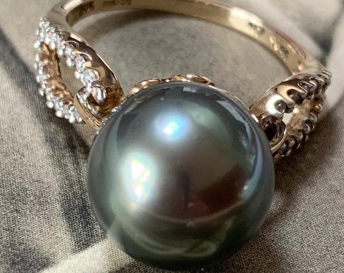 Black pearl and diamond ring. 11.6 mm south sea pearl with 0.14ct brilliant cut diamonds. Hallmarked 4.4 gram Size N 1/2 6 3/4 (US)