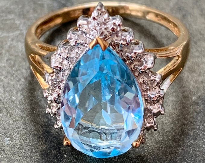 Blue Topaz 9ct gold ring with diamonds. 4.07ct Pear cut gemstone. 2005 English hallmark. Ring size N or 6.5 US. 3.5 grams