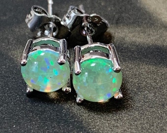 Opal silver ear studs with butterfly backs. Synthetic opal has a beautiful green color that adds natural vibrancy